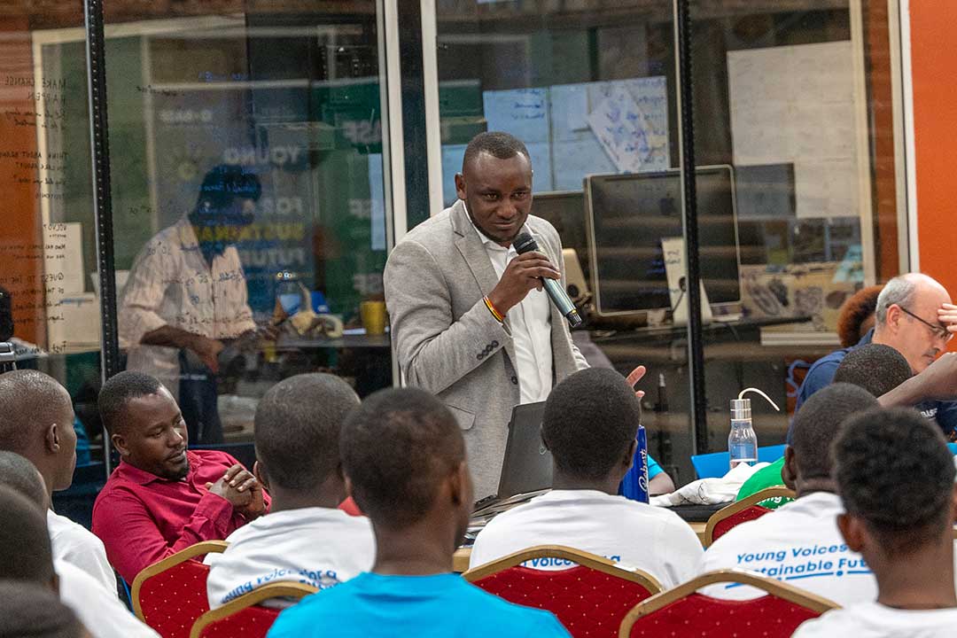 Alex Taremwa speaks in May to participants of the Junior Achievement climate change innovation challenge where he was a judge